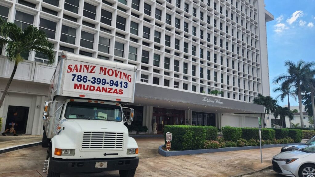 "Sainz Moving crew loading furniture onto a moving truck for home relocation"